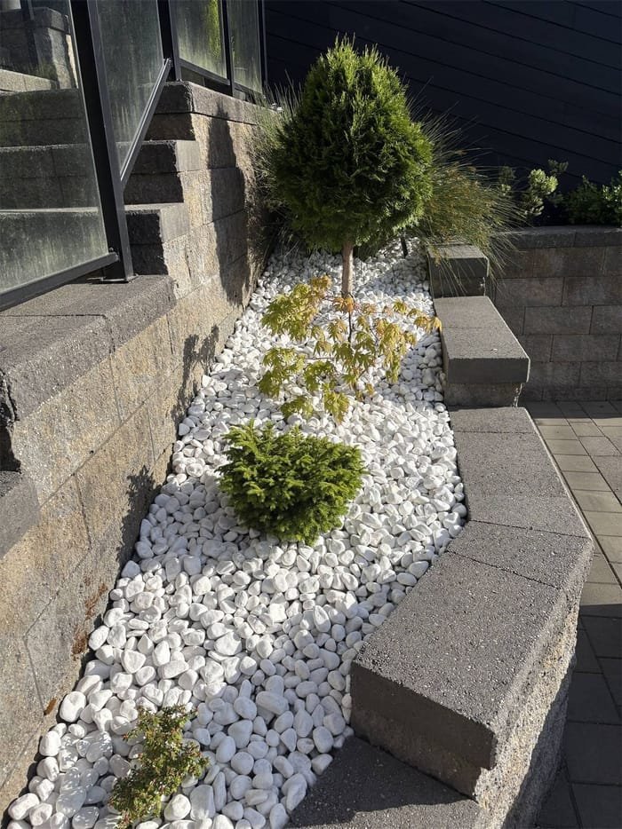 Rock garden bed with ornamental plantings in Metro Vancouver