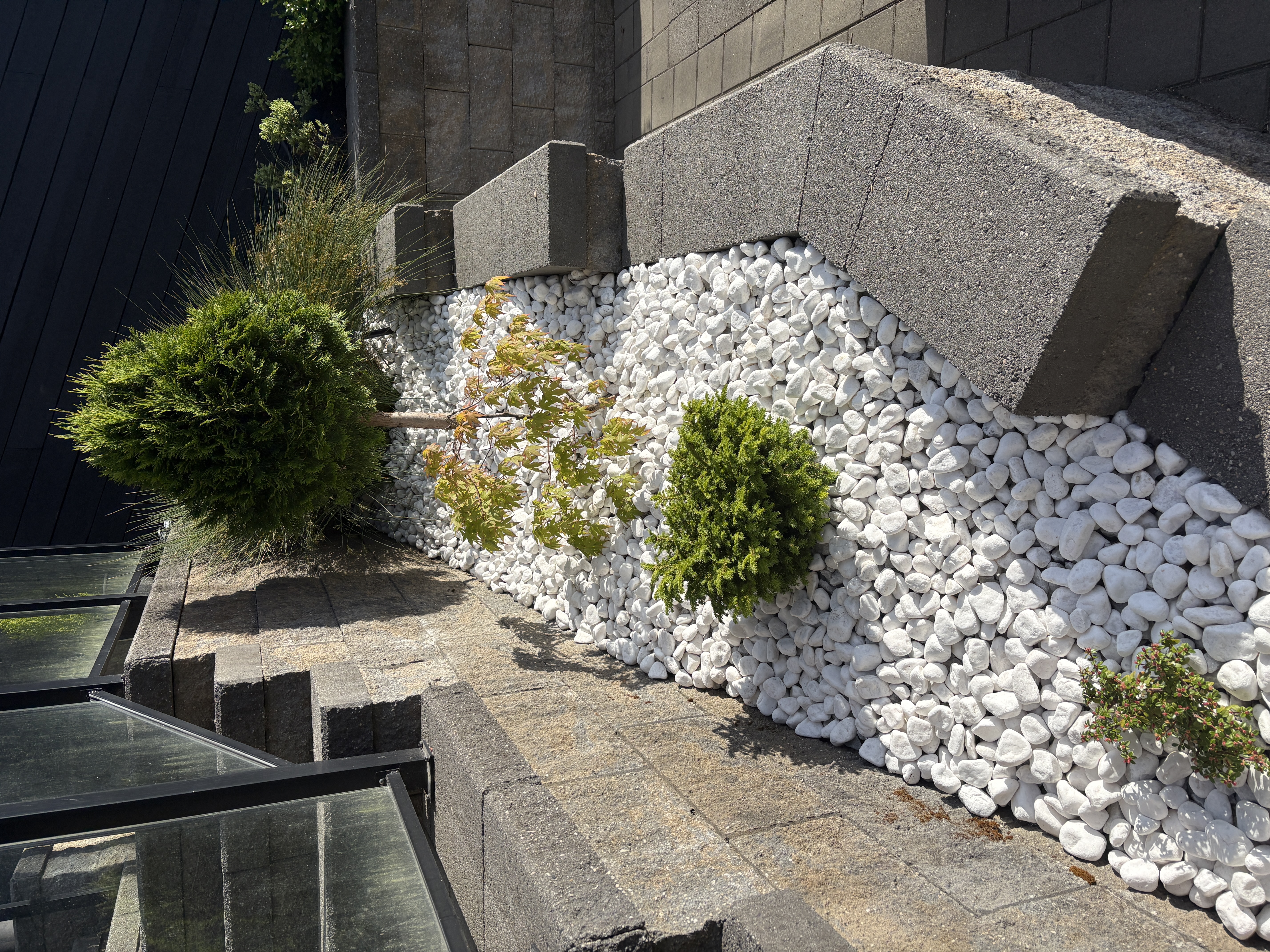Rock garden bed with ornamental plantings in Metro Vancouver
